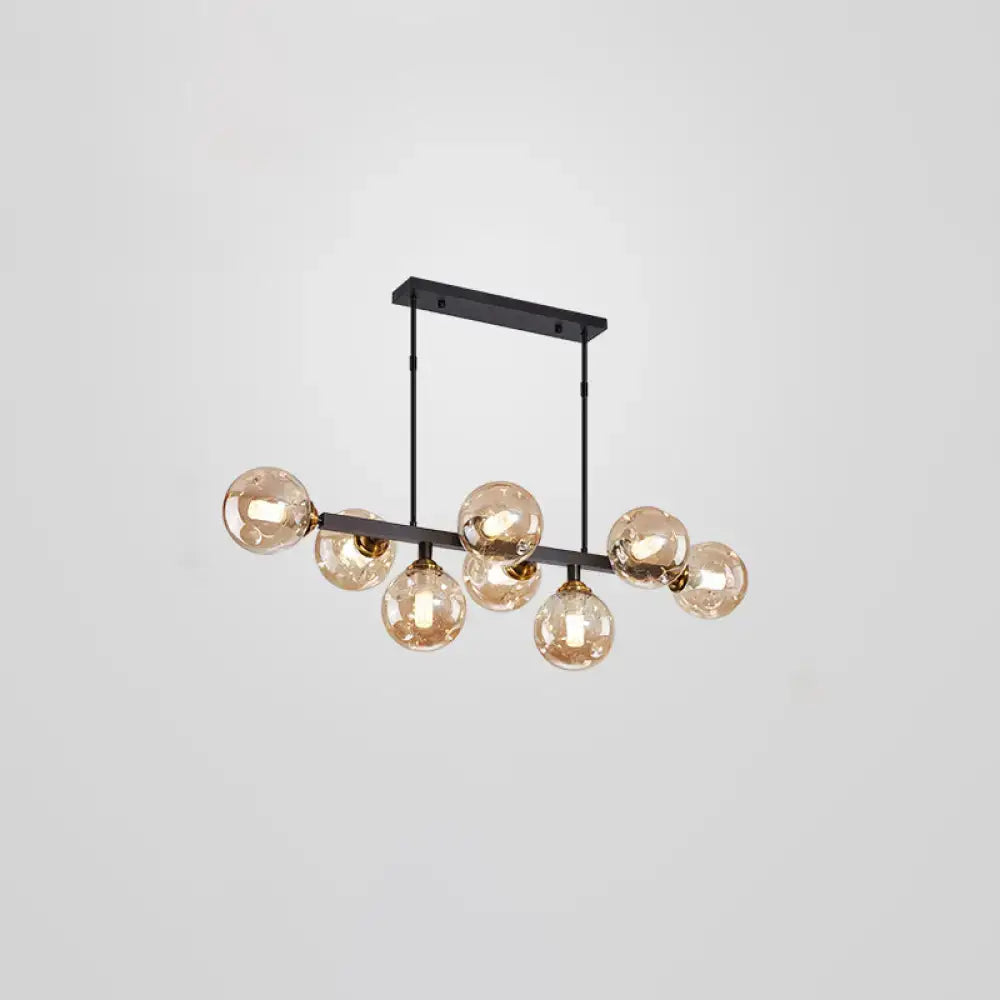 Modern black metal pendant light with seven amber glass globe bulbs featuring stylish postmodern light features