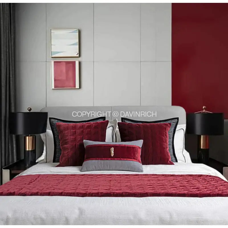 Decorbites burgundy velvet geometric embroidered bed runner with red quilted velvet textured pattern over white bedding