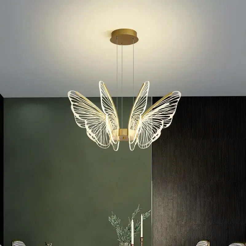 Gold-toned decorbites butterfly led chandelier pendant light with intricate white wireframe wings for bedroom use