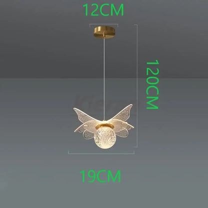 A delicate gold-toned decorbites butterfly led pendant light with intricate wirework wings and frosted glass globe
