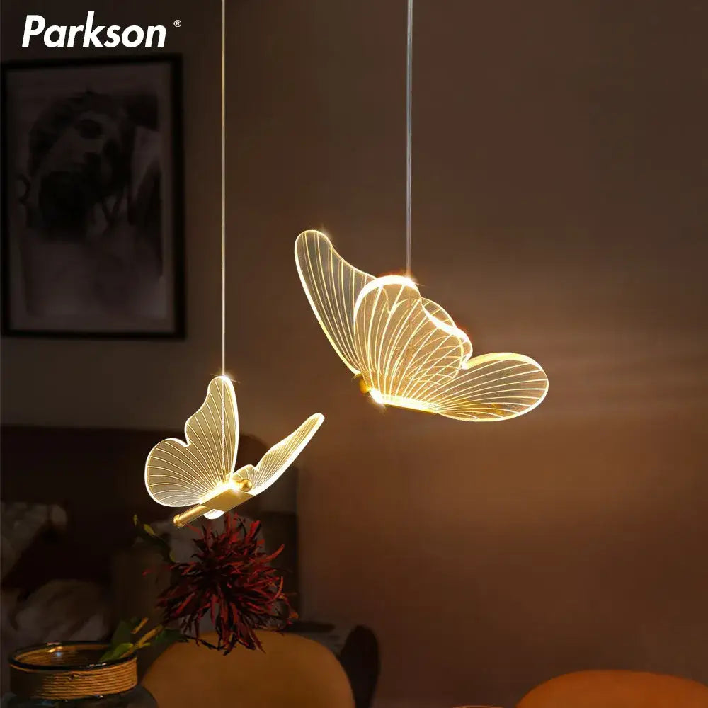 Decorbites butterfly led pendant light by Parkson with illuminated translucent wings and glowing golden interiors for living room