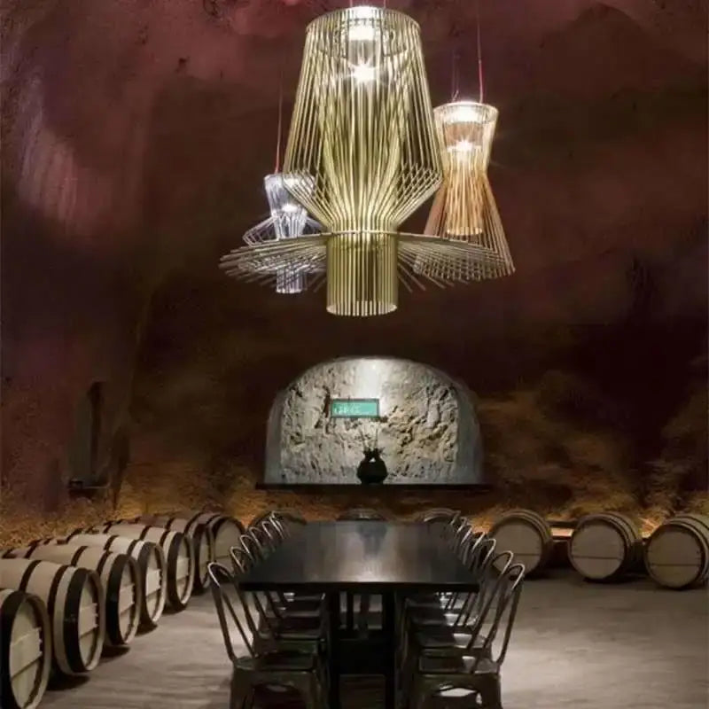 A modern decorbites cage industrial pendant light with golden metallic frame and intricate wire mesh for kitchen dining room