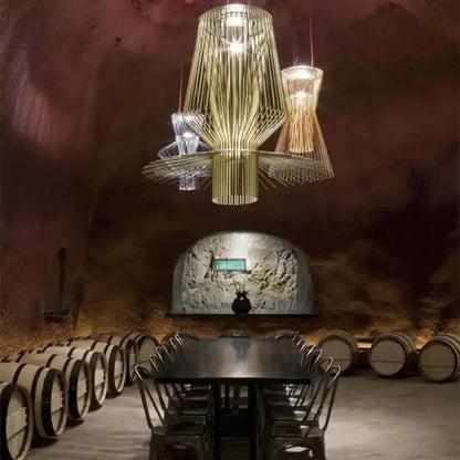 A modern decorbites cage industrial pendant light with golden metallic frame and intricate wire mesh for kitchen dining room