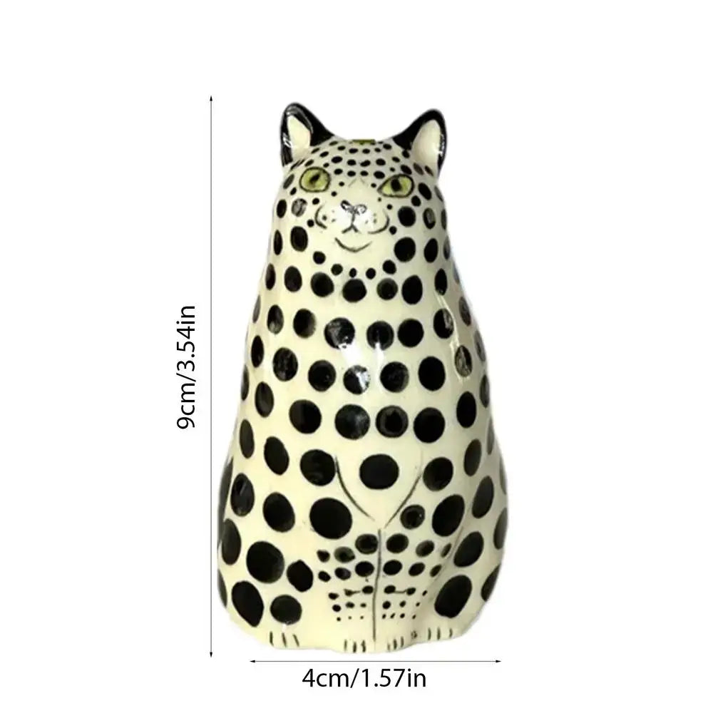 Cream-colored ceramic dot cat figurine with black spots and green eyes in decorbites polka dot cat vase