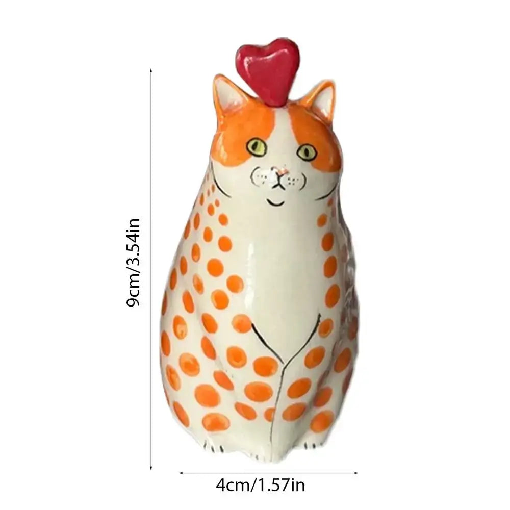 A charming orange and white polka dot resin cat vase with a glossy finish and red heart by DecorBites™