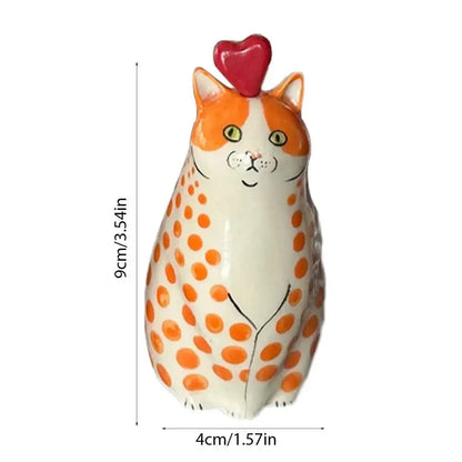 A charming orange and white polka dot resin cat vase with a glossy finish and red heart by DecorBites™