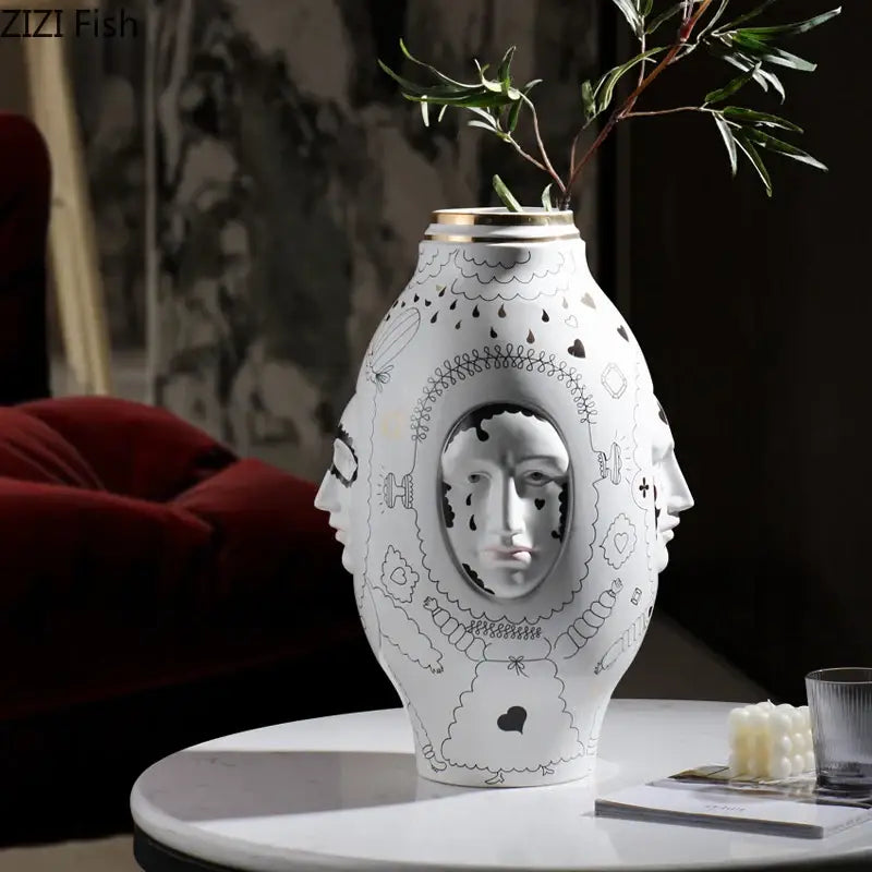 White ceramic vase desktop with black line art faces patterns and a gold rim for floral arrangements by DecorBites™
