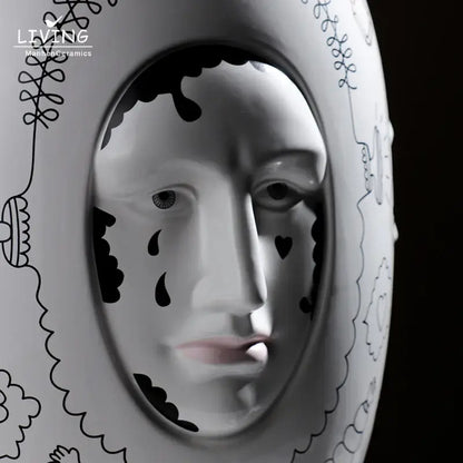 White ceramic vase desktop with black ink-drawn face design and decorative patterns for floral arrangements