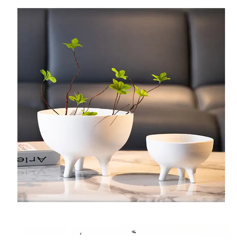 DecorBites ceramic flower pot with tripod stand in white ceramic featuring a minimalist tri-legged glossy design