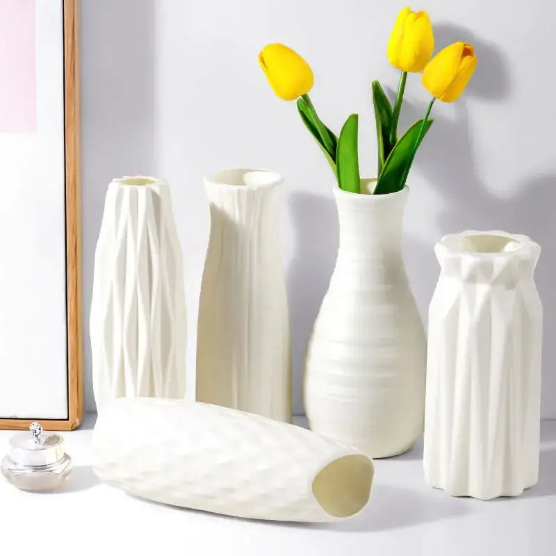A sleek white ceramic-look plastic vase imitation with geometric facets and vertical ridges for home and garden decor