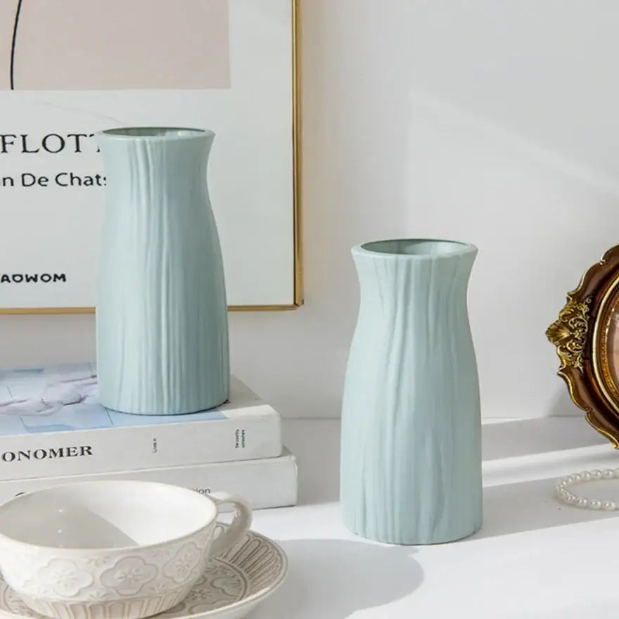 Two light blue ceramic-look plastic vase imitation flower pots with vertical ribbed texture for home and garden decor