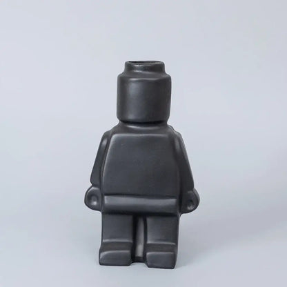 Black ceramic robot vase shaped like a lego minifigure for nordic style home decor by DecorBites