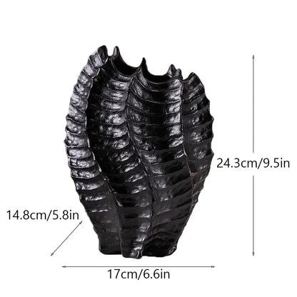 Black glossy resin sculpture shaped like a segmented insect exoskeleton featured with decorbites ceramic sea vase nordic modern decor