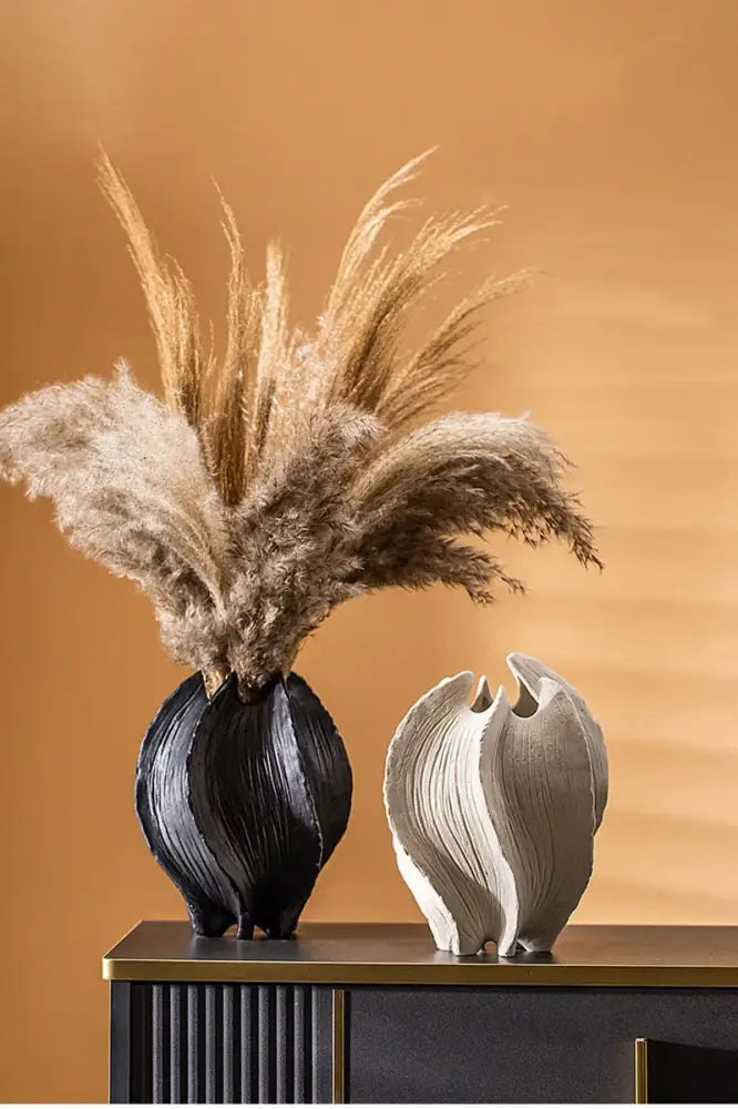 Black and white ceramic sea vase with sculpted ribbed surfaces in nordic modern style by DecorBites