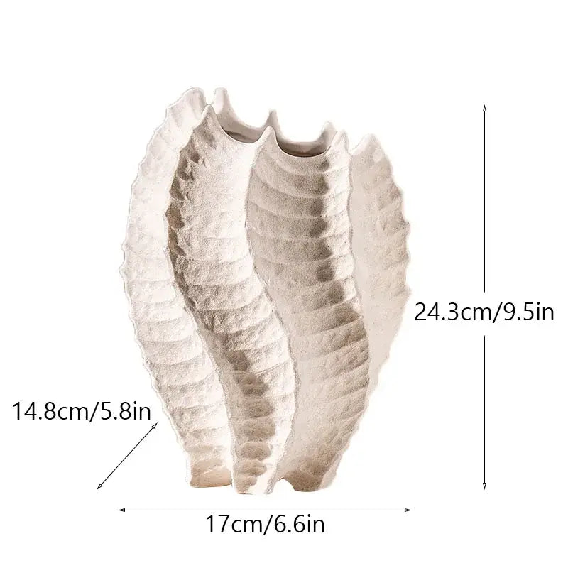 Cream-colored textured ceramic sea vase with sculpted shell-like design for nordic modern decor by DecorBites