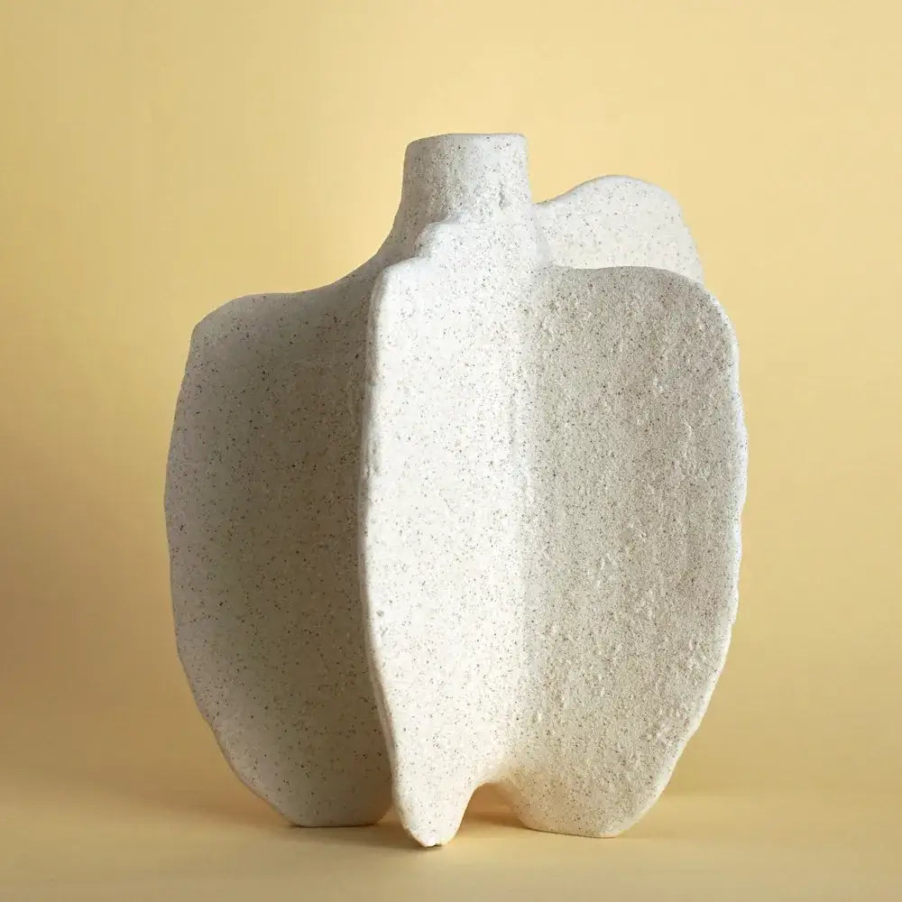 White speckled ceramic sea vase with organic asymmetrical contours for nordic modern decor by DecorBites