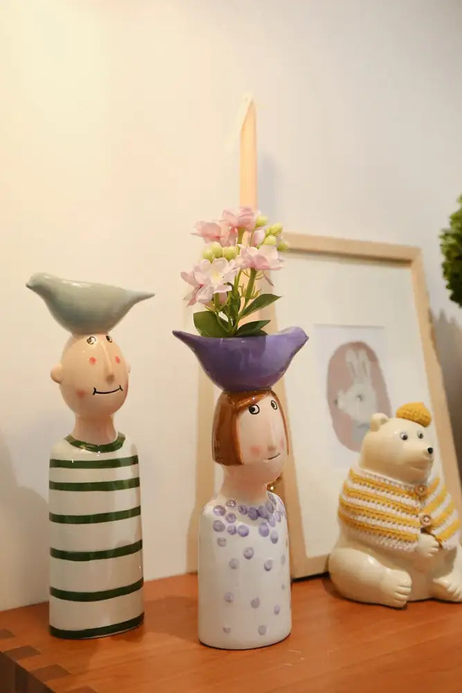 DecorBites™ ceramic vase set featuring a purple ceramic vase shaped like a woman with brown hair and pink flowers for home decor