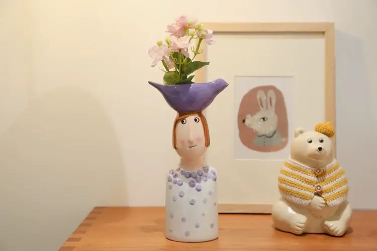 DecorBites™ ceramic vase shaped like a woman with purple hat and polka-dotted dress for elegant home decor