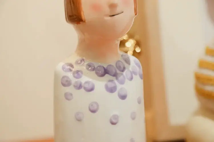 Decorbites™ ceramic vase set featuring a white ceramic figurine with brown hair and purple polka dots for home decor