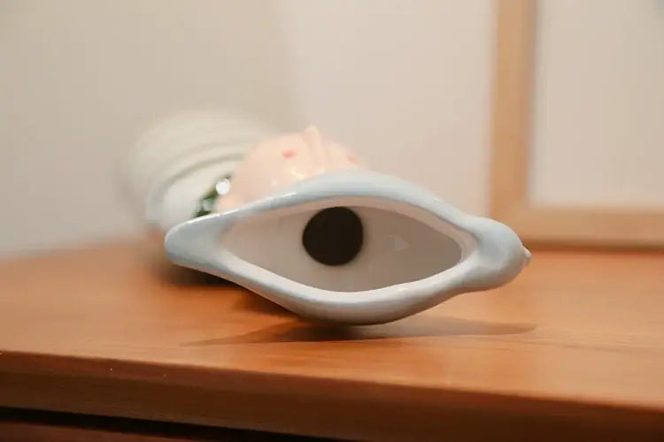 White ceramic vase from DecorBites™ ceramic vase set with stylized eye design for elegant home decor