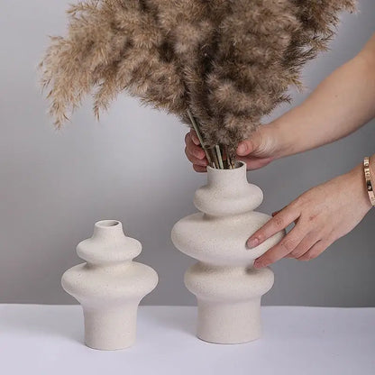 Cream-colored ceramic vase with stacked rounded segments and textured surface from DecorBites ceramic vases for home decor