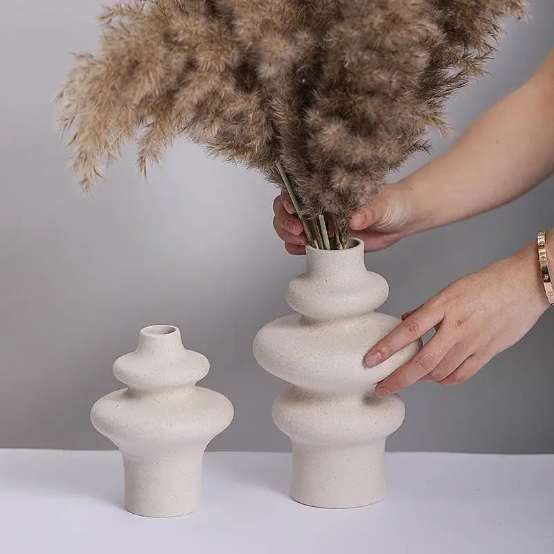 Cream-colored ceramic vase with stacked rounded segments and textured surface from DecorBites ceramic vases for home decor