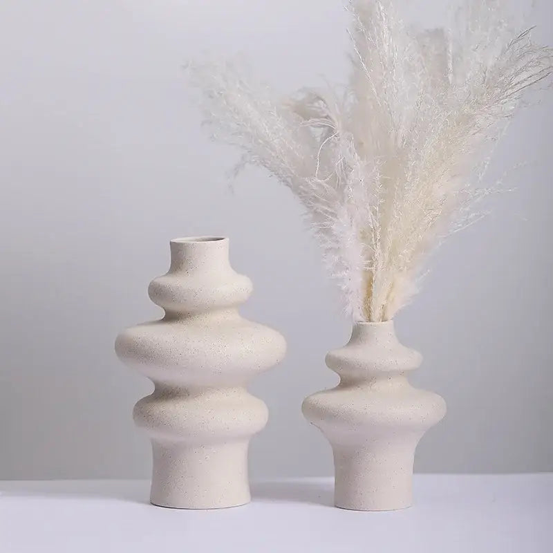 Cream-colored ceramic vases with a textured speckled finish and stacked rounded tiers for modern home decor by decorbites