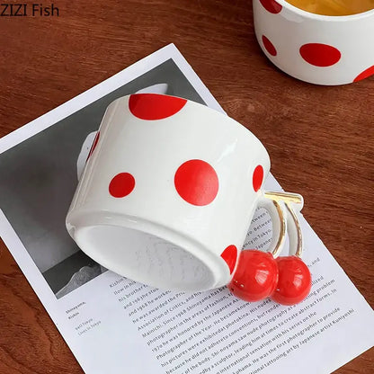 White ceramic coffee mug with bold red polka dots and decorbites cherry handle gold plated porcelain design