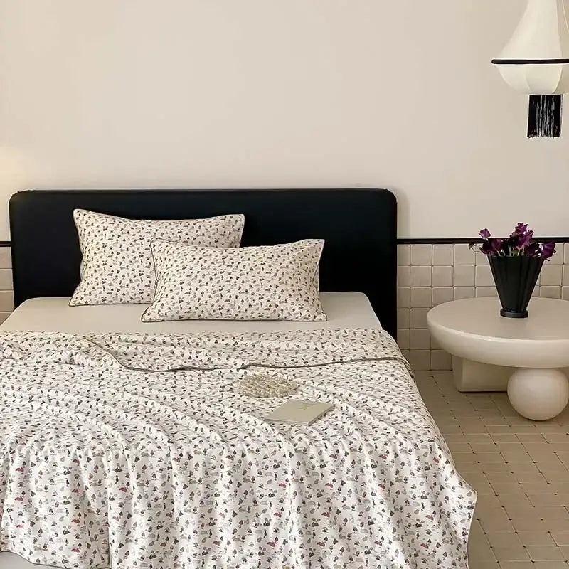 White bedding set with delicate gray and muted pink floral pattern featuring decorbites cherry lyocell fiber cooling blanket