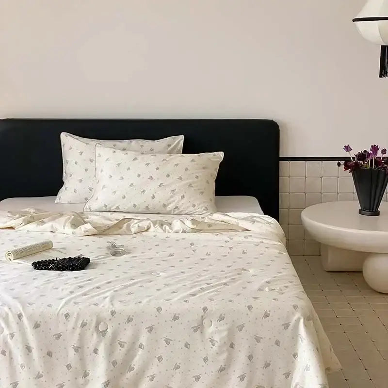 Cream-colored satin bedding set with subtle gray bunny print featuring decorbites cherry lyocell fiber cooling properties