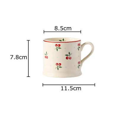 Cream-colored DecorBites cherry pattern porcelain coffee mug with red cherries green leaves and a thin red rim for afternoon tea