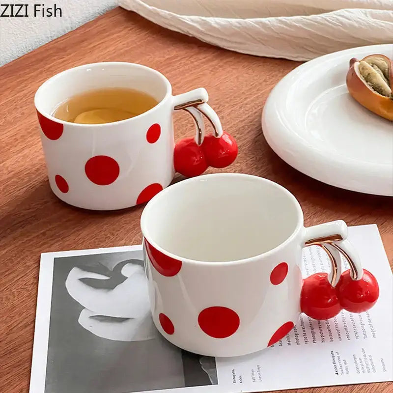 White ceramic decorbites cherry porcelain mug with red polka dots and cherry-shaped handle for coffee or tea