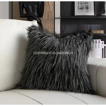 A plush black and silver faux fur pillow case with textured fringed edge on white leather sofa by decorbites chestnut brown wabi