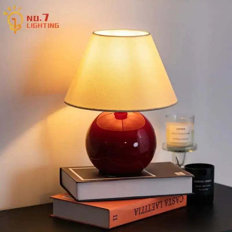 Glossy red ceramic DecorBites chestnut glass table lamp with warm beige fabric shade for bedroom and living room use
