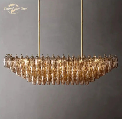Gold-toned decorbites chiara smoke tiered chandelier with faceted amber smoke glass shades and brass hardware