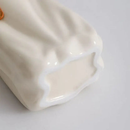 Cream-colored chic ceramic vase from decorbites™ with glossy finish and soft ruffled texture for home decoration