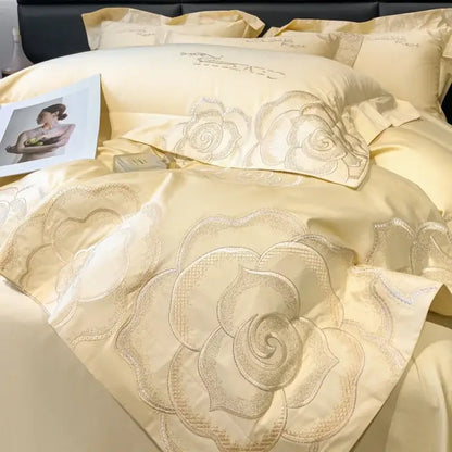 Cream-colored satin bedding set with intricate silver-threaded rose embroidery by decorbites chic embroidered cotton