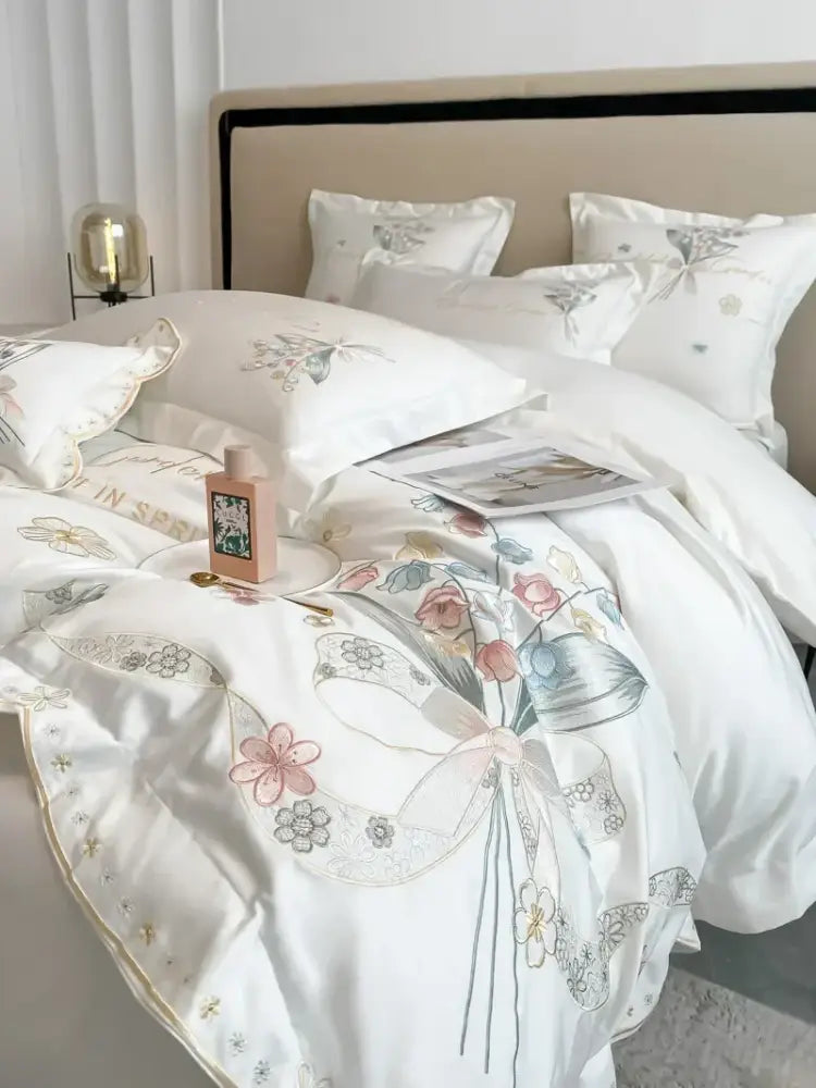 White satin duvet cover with decorbites chic flowers embroidery in soft pink blue gray hues made of 100% egyptian cotton