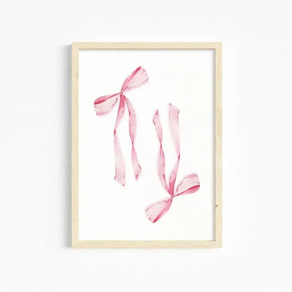 DecorBites™ chic pink wall art featuring a delicate watercolor print of pink ribbons in a light wood frame for girls room