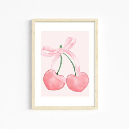 A framed watercolor print of two pink heart-shaped cherries tied with a ribbon bow for girls room pink wall art