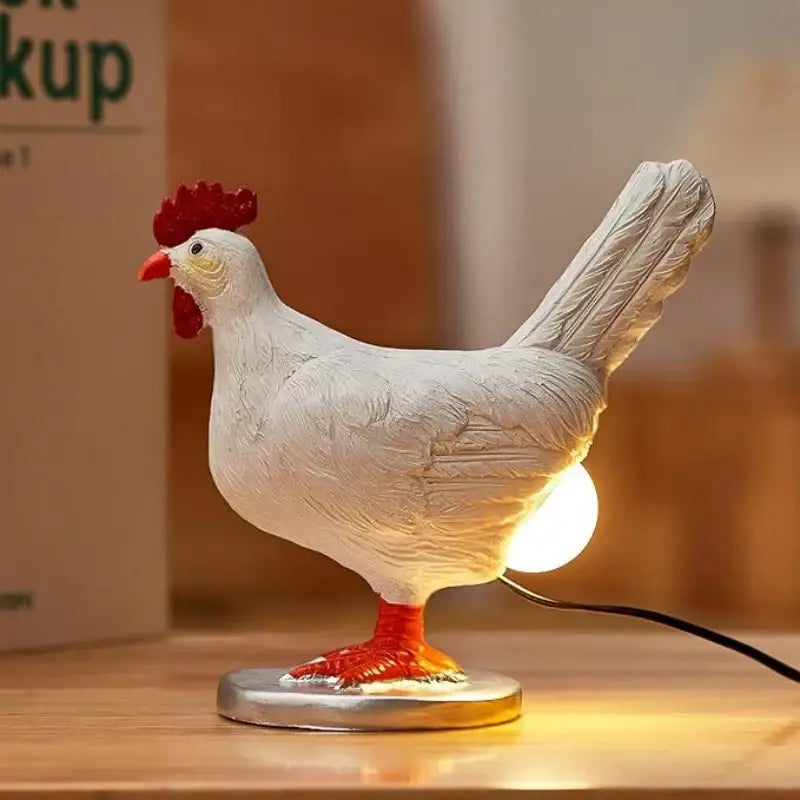 DecorBites™ chick night light ornament is a white chicken-shaped light ornament with red comb and feet on a silver base