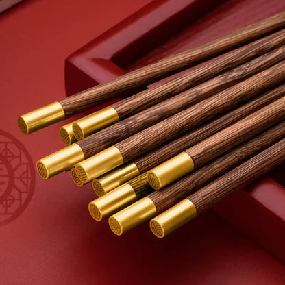 Set of elegant decorbites™ chicken-wing wood chopsticks set with dark wood and gold metal engraved tips