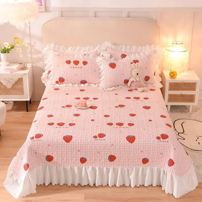 Pink strawberry-patterned decorbites chiffon quilted queen size cotton bedspread with white ruffled edges and checkered background