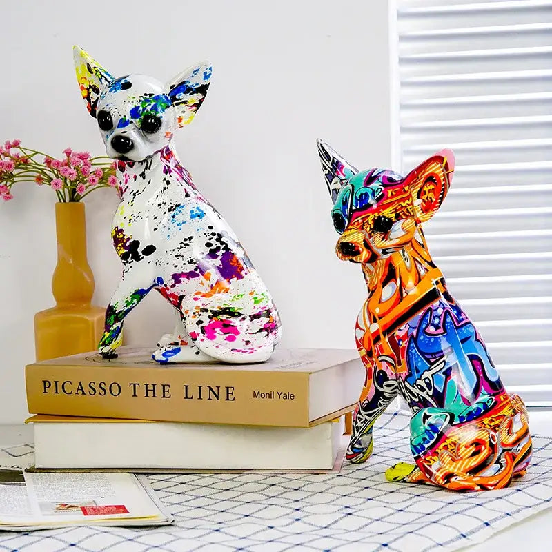 Two vibrant resin decorbites chihuahua splash color figurines with glossy finish atop stacked books for decorbites chihuahua splash