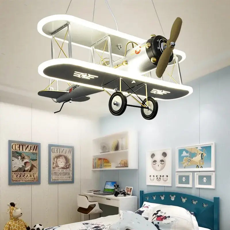 DecorBites™ children’s aircraft led chandelier shaped like a white and black double-decker airplane with gold accents