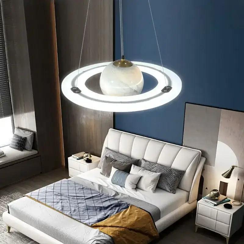 DecorBites™ children’s planet earth pendant lamp with white marble sphere and glowing acrylic rings above bed