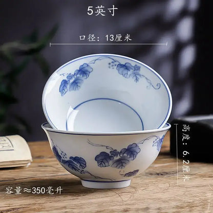 A pair of elegant white porcelain vegetable plates and rice soup bowls with blue floral patterns by decorbites