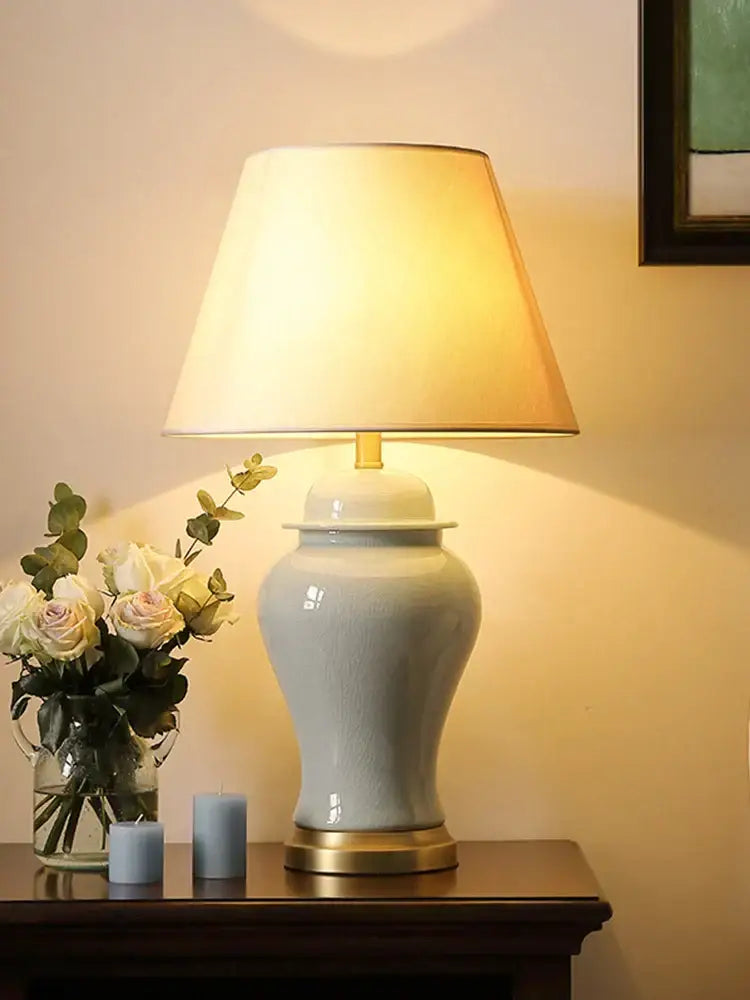 A sleek light blue ceramic table lamp with gold-toned base and finial for living room and bedroom decor