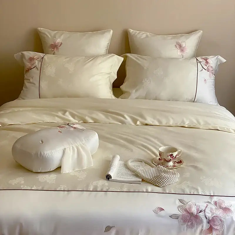 Cream-colored satin bedding set with pink floral embroidery made of lyocell cotton in decorbites Chinese floral style