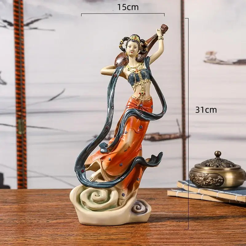 A detailed resin decorbites™ chinese goddess fairy figurine in orange and blue robe holding a musical instrument for home decor